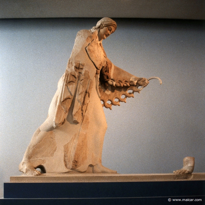 6415.jpg - 6415: About 520 BC. Athena. Pediment of the archaic temple of Athena which was erected by the sons of Peisistratos. Gigantomachy. Acropolis Museum, Athens.