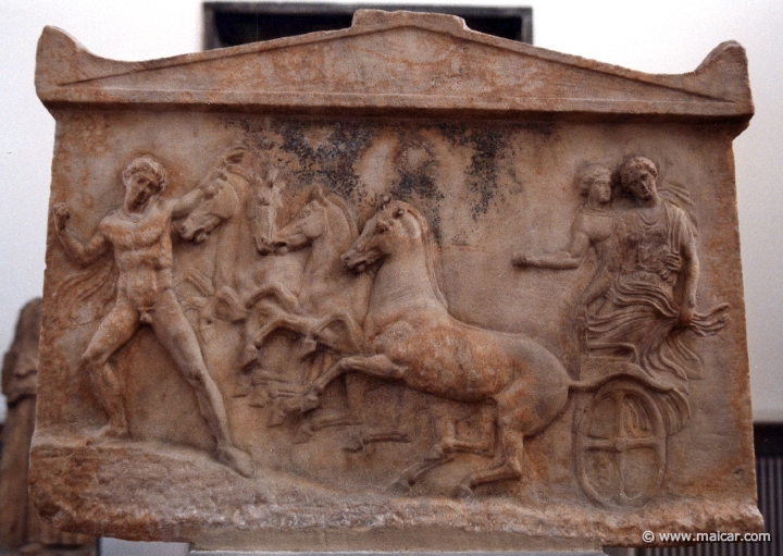 6308.jpg - 6308: Double votive relief. Side A: The hero Echelos on a quadriga with the nymph Basile. In front of them Hermes holding a whip. About 410 BC. National Archaeological Museum, Athens.