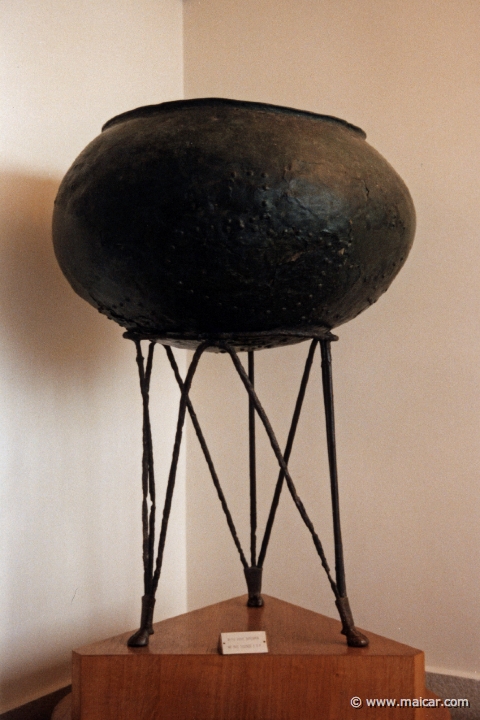 5934.jpg - 5934: Bronze cauldron supported by a tripod whose iron legs end in ox hooves of bronze, 7C BC. Archaeological Museum, Delphi.