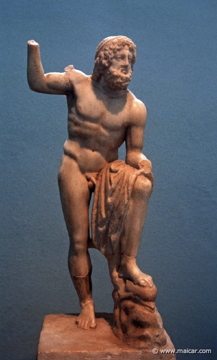 6514.jpg - 6514: Statuette of Poseidon. The base is on a Ionic capital. Roman period. Archaeological Museum of Eleusis.