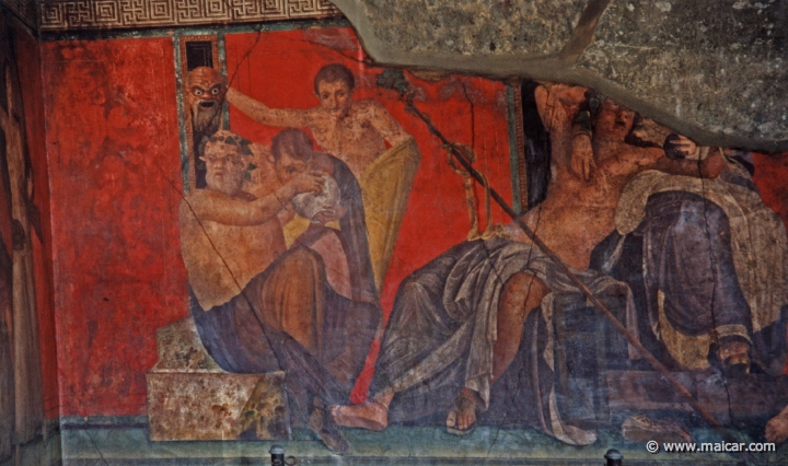 7416.jpg - 7416: Villa dei Misteri, Pompeii. From left to right: Silenus giving a drink to a young Satyr, while another Satyr holds up a frightening mask; Dionysus sits with Ariadne; initiates. Pompeii.
