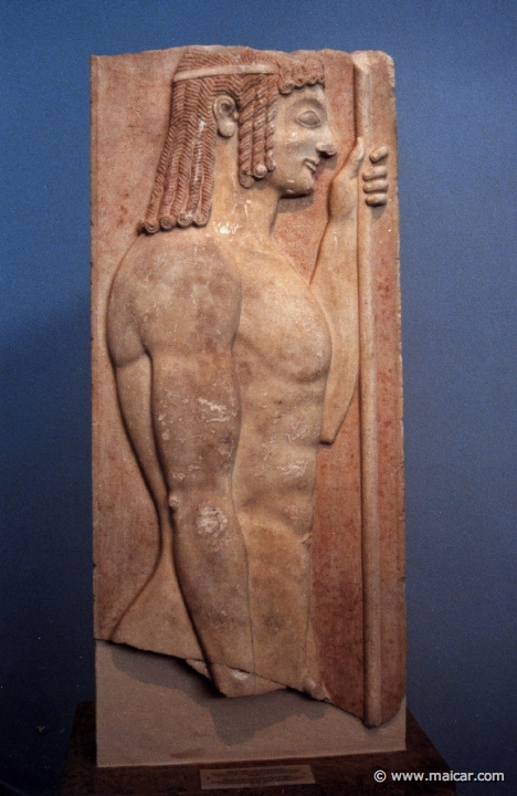 6129.jpg - 6129: Grave stele. Parian marble. Found in Athens. It was one built into the Themistokleian wall. The relief represents a young doryphoros to the right, against a red background. 530-540 BC. National Archaeological Museum, Athens.
