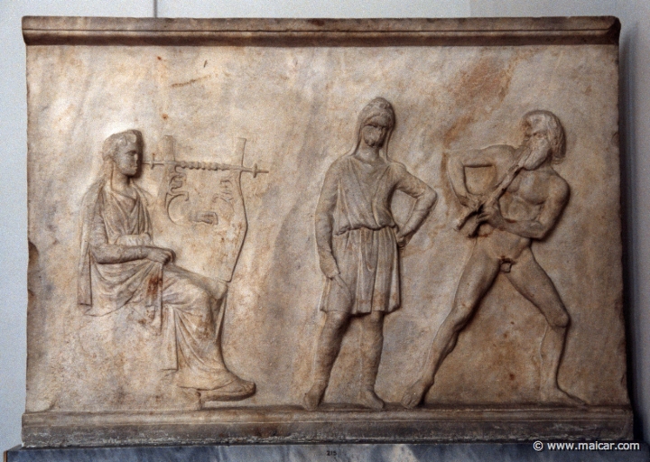 6227.jpg - 6227: “Base of Mantineia”. Apollo playing a kithara and Marsyas playing a double flute. A Scythian is ready to flay Marsyas. Found at Mantineia, Peloponnese, around 320 BC. National Archaeological Museum, Athens.