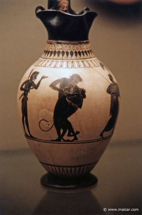 8126.jpg - 8126: White-ground oinochoe (wine-jug). Athens about 520-500 BC. Herakles and the Nemean lion. British Museum, London.